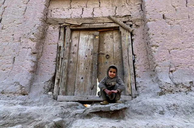 Abdullah, 6, An Afghan boy, sits in front of his home on the outskirts of Jalalabad city east of Kabul, Afghanistan, Thursday, February 4, 2021. (Photo by Rahmat Gul/AP Photo)