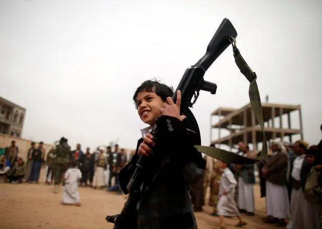 A boy carries a weapon as he attends a tribal gathering held to show support to the Houthi movement in Sanaa, Yemen November 10, 2016. (Photo by Khaled Abdullah/Reuters)