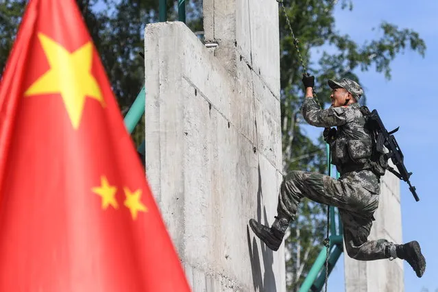 A serviceman of the Chinese People's Liberation Army (PLA) during the Scout Trail obstacle course, a stage of the Army Scout Masters competition among reconnaissance units, as part of the 2018 International Army Games at the Koltsovo range in Novosibirsk region, Russia on August 1, 2018. (Photo by Kirill Kukhmar/TASS via Getty Images)