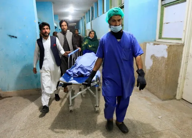 Afghan men transport the body of one of three female media workers who were shot and killed by unknown gunmen, at a hospital in Jalalabad, Afghanistan on March 2, 2021. Three female media workers were shot dead amid a wave of killings that is spreading fear among professional workers in urban centers. Zalmai Latifi, head of local broadcaster Enikas TV, said the three women were recent high school graduates aged between 18 and 20 who worked in the station's dubbing department. A wave of shootings and small bombs attached to vehicles in have targeted journalists, civil society workers and mid-level government employees in recent months. (Photo by Parwiz via Reuters)