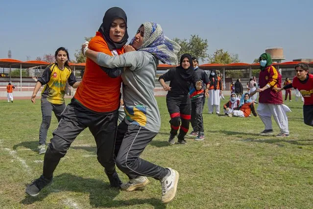 Students are seen playing soccer in a field in Peshawar on March 8, 2021 on the International Women's day. (Photo by Abdul Majeed/AFP Photo)