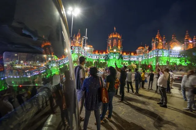 City landmark Chatrapati Shivaji Maharaj terminus building is lit in the colors of the Indian flag on the eve of Independence Day in Mumbai, India, Monday, August 14, 2023. (Photo by Rafiq Maqbool/AP Photo)