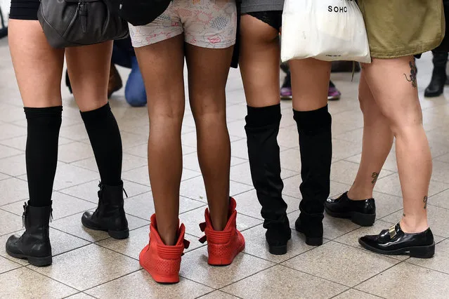 Participants in the "No Pants Subway Ride"  stand on a New York City subway platform January 10, 2016 in New York. (Photo by Timothy A. Clary/AFP Photo)
