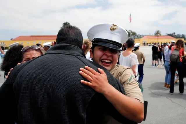 Private First Class Ann Parra hugs her dad Efrain, as members of Lima Company's 3rd Recruit Training Battalion celebrate after they become the first women to graduate as U.S. Marines in the 100-year history of Marine Corps Recruiting Depot San Diego, in San Diego, California, May 6, 2021. (Photo by Mike Blake/Reuters)