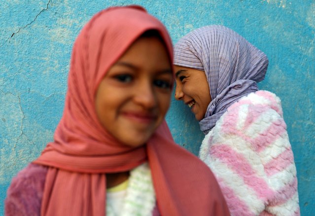 Khadija Amchichar, 12, and Amina Ouazzou, 8, react as they stand in a school turned into a shelter for displaced earthquake survivors, in the aftermath of a deadly earthquake, in the village of Outaghrri, Morocco on September 13, 2023. (Photo by Hannah McKay/Reuters)