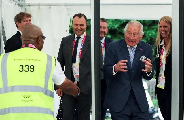 Britain's Prince Charles, Prince of Wales reacts as he walks through a metal detector as he arrives for a visit to the Athletes Village at The University of Birmingham in Birmingham, central England, on July 28, 2022, on the eve of the Commonwealth Games. (Photo by Phil Noble/Pool via AFP Photo)