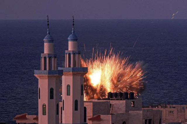 A fireball erupts from an Israeli airstrike in Gaza City on October 12, 2023. Thousands of people, both Israeli and Palestinian, have died since October 7, after Palestinian Hamas militants entered Israel in a surprise attack leading Israel to declare war on Hamas in the Gaza Strip enclave. (Photo by Mahmud Hams/AFP Photo)