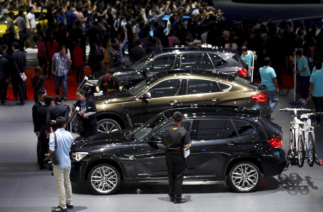 Visitors gather around displays during a media presentation of the 36th Bangkok International Motor Show in Bangkok March 24, 2015. (Photo by Chaiwat Subprasom/Reuters)