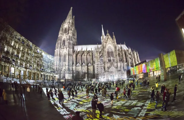 A fisheye lens view of visitors during a Light installation by the German Artist Philipp Geist in front of the cathedral during New Year's Eve celebrations in Cologne, Germany, 31 December 2016. (Photo by Ronald Wittek/EPA)