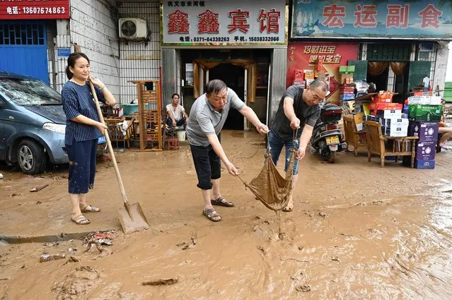 People clear muds out from their residences after severe flooding and landslide in recent days have hit the county-level Gongyi city, near Zhengzhou, in central Chinas Henan province on July 22, 2021. (Photo by Jade Gao/AFP Photo)