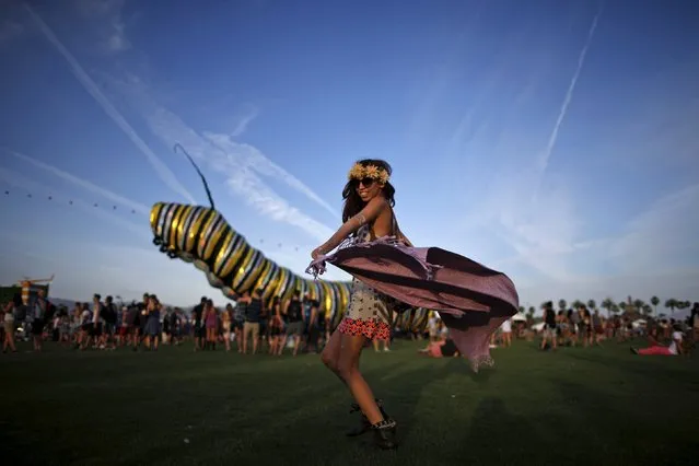 Melissa Gasia, 24, dances in front of an artwork called “Papilio Merraculous” by Poetic Kinetics at the Coachella Valley Music and Arts Festival in Indio, California April 10, 2015. (Photo by Lucy Nicholson/Reuters)