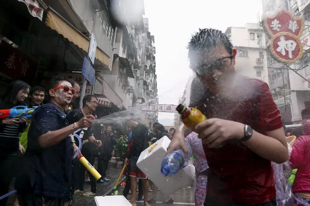 A reveller reacts as he gets sprayed by water guns during Songkran Festival celebrations at Kowloon City district, known as Little Thailand as there is large number of restaurants and shops run by Thais, in Hong Kong April 12, 2015. (Photo by Tyrone Siu/Reuters)