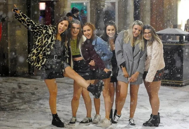 It may be snowing, but these young women still found time for a quick snap in Newcastle, England last night, February 1, 2019. (Photo by Will Walker/North News and Pictures)