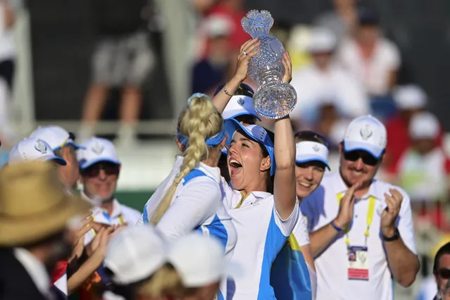Europe's Georgia Hall holds up the trophy after their team defeated the United States at the Solheim Cup golf tournament, Monday, September 6, 2021, in Toledo, Ohio. (Photo by David Dermer/AP Photo)