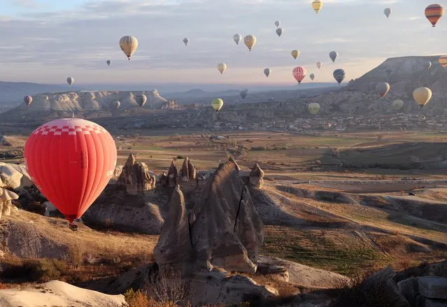 A view of hot air balloons flying over valleys of Cappadocia in Nevsehir, Turkiye on December 05, 2023. In 1987, a trial flight with hot air balloons paved the way for a major touristic sector with over 3700 daily visitors and 632 pilots flying over the historical region. (Photo by Behcet Alkan/Anadolu via Getty Images)