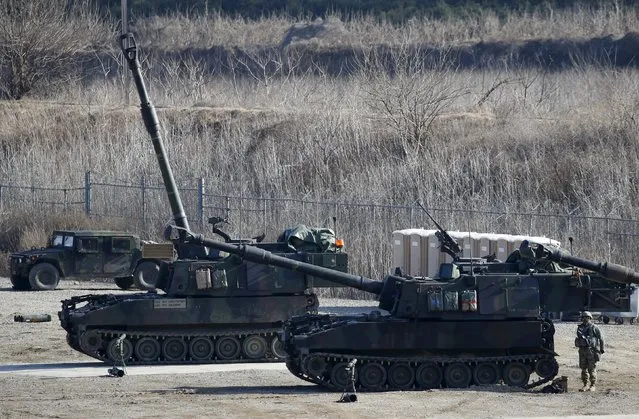 A U.S. Army soldier stands behind their M109A6 Paladin self-propelled howitzers during a military exercise in Pocheon, South Korea, March 10, 2016. (Photo by Kim Hong-Ji/Reuters)