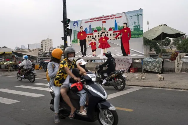 A billboard campaigning for each family to have two children in an effort to improve the birth rate stands along the street in Ho Chi Minh City, Vietnam, January 14, 2024. (Photo by Jae C. Hong/AP Photo)