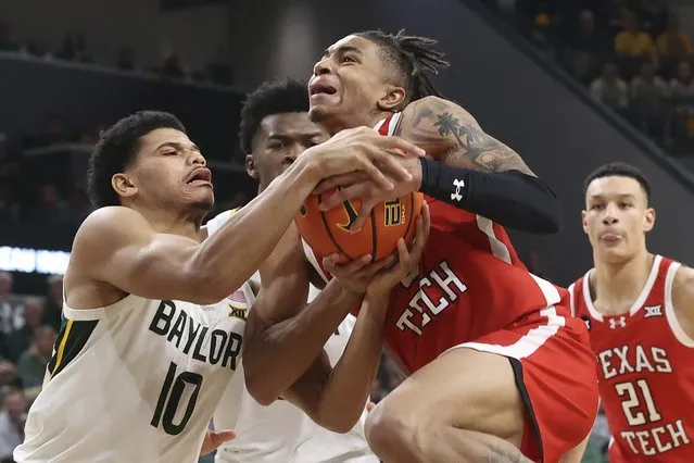 Texas Tech guard Chance McMillian (0), right, and Baylor guard RayJ Dennis (10), left, battle for control of the ball during the second half of an NCAA college basketball game Tuesday, February 6, 2024, in Waco, Texas. (Photo by Jerry Larson/AP Photo)