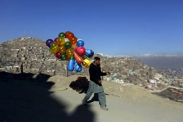 An Afghan man holds balloons for sale in Kabul, Afghanistan February 22, 2016. (Photo by Mohammad Ismail/Reuters)