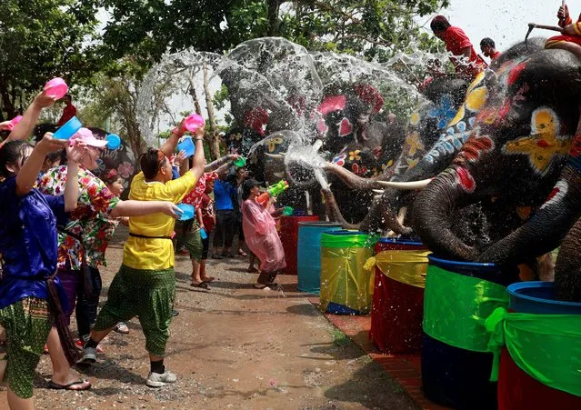 Elephants and people play with water as part of celebrations for the water festival of Songkran in Ayutthaya, Thailand on April 11, 2019. (Photo by Soe Zeya Tun/Reuters)