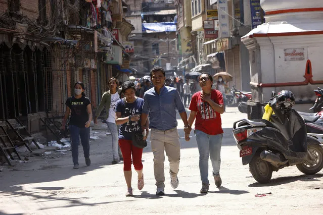 Nepalese people rush to safer areas as an earthquake hits Kathmandu, Nepal, Tuesday, May 12, 2015. (Photo by Bikram Rai/AP Photo)