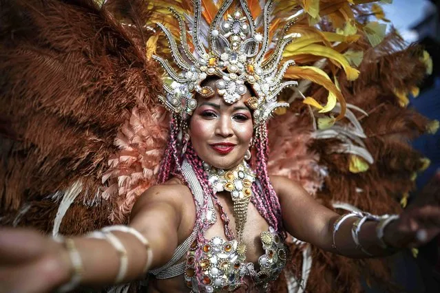 A woman takes part in a carnival parade as part of New Year's Eve festivities in San Jose, Costa Rica, 27 December 2023. (Photo by Jeffrey Arguedas/EPA/EFE)