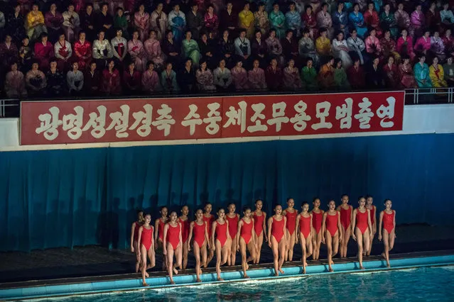 Swimmers perform in a syncronised swimming gala event in Pyongyang on February 15, 2017. The gala was part of a series of events being held to celebrate the birth of late North Korean leader Kim Jong- Il, who oversaw the country' s first nuclear tests. (Photo by Ed Jones/AFP Photo)