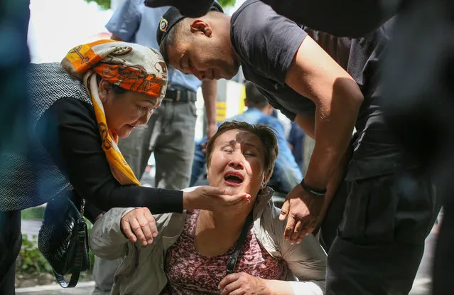 A police officer (R) detains an opposition supporter on June 10, 2019 in Almaty, a day after Kazakhstan's presidential elections. Kazakhstan elected the hand-picked successor of former president Nursultan Nazarbayev with more than 70 percent of the vote, electoral authorities said, after an election day marred by protests. (Photo by Ruslan Pryanikov/AFP Photo)