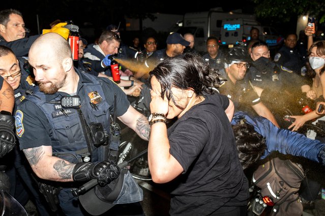 Officers of the Metropolitan Police Department pepper spray demonstrators at George Washington University, early Wednesday, May 8, 2024, in Washington. Police cleared a pro-Palestinian tent encampment at George Washington University and arrested demonstrators early Wednesday, hours after dozens marched to the home of the school’s president. (Photo by Sage Russell, GW Hatchet via AP Photo)