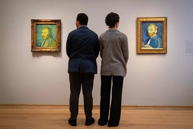 Two gallery staff members look at two self-portraits paintings by Dutch artist Vincent Van Gogh, during the media preview of the exhibition “Van Gogh self-portraits”, at The Courtauld Gallery in London, on February 1, 2022. The exhibition will run from February 3, 2022 until May 8, 2022. (Photo by Tolga Akmen/AFP Photo)