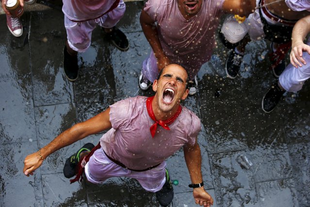 Revellers get soaked with water during the start of the San Fermin Festival in Pamplona, Spain, July 6, 2015. (Photo by Susana Vera/Reuters)