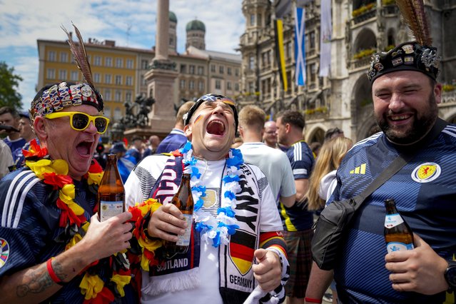 Soccer fans share a laugh in the 'Marienplatz' square, before a Group A match between Germany and Scotland at the Euro 2024 soccer tournament in Munich, Germany, Friday, June 14, 2024. (Photo by Markus Schreiber/AP Photo)