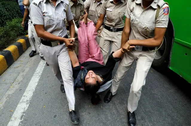 Police detain an activist of the youth wing of India's main opposition Congress party during a protest against an economic slowdown, in New Delhi, India, September 20, 2019. (Photo by Anushree Fadnavis/Reuters)