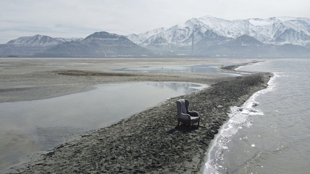 A chair sits on an exposed sand bar on the southern shore of the Great Salt Lake on March 3, 2022 near Salt Lake City, Utah. Utah lawmakers passed a $40 million proposal through the state Senate that would pay water rights holders to conserve and fund habitat restoration to prevent the lake from shrinking further. (Photo by Rick Bowmer/AP Photo)