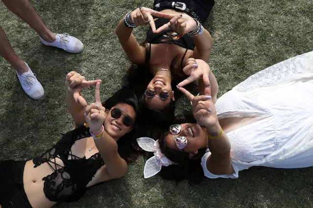 People pose for photos during the Coachella Valley Music and Arts Festival on April 17, 2017 in Indio, California. (Photo by Carlo Allegri/Reuters)