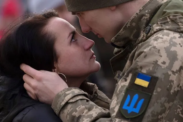 Andrew says goodbye to his partner Yarina before boarding a train to Dnipro from the main train terminal on March 09, 2022 in Lviv, Ukraine. As Ukrainian civilians in the east flee to the relative safety of western cities such as Lviv, and abroad to escape Russia's assault, many military personnel are heading east to help with the war effort. (Photo by Dan Kitwood/Getty Images)