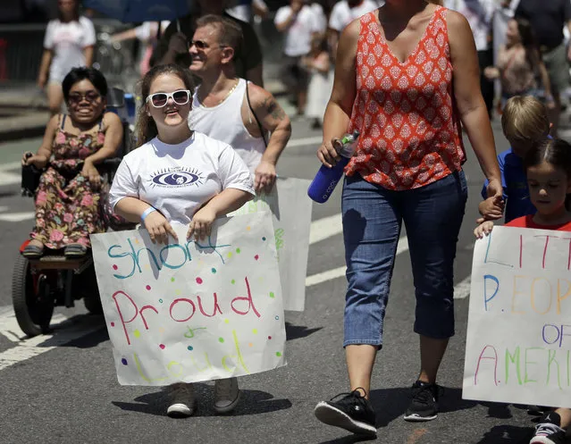 Madison Ehler marches in the inaugural Disability Pride Parade, Sunday, July 12, 2015, in New York. (Photo by Seth Wenig/AP Photo)