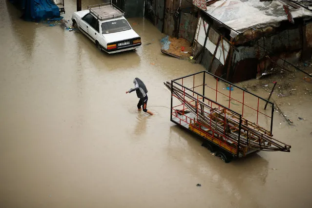 A Palestinian walks through flood water following heavy rain in a neighbourhood in the northern Gaza Strip February 16, 2017. (Photo by Mohammed Salem/Reuters)