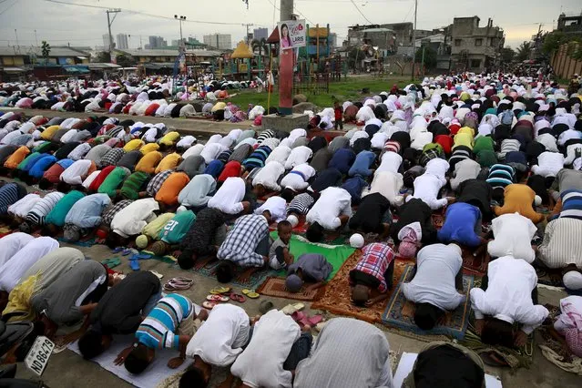 Muslim residents offer their morning prayers at a park in a slum area in Tondo, metro Manila July 17, 2015. (Photo by Romeo Ranoco/Reuters)