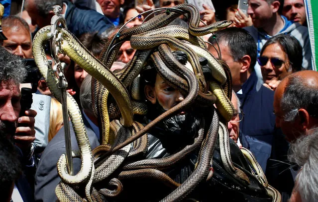 Snakes cover a wooden statue of Saint Domenico during a procession in Cocullo, central Italy. Every year in May, snakes are placed onto the statue of St. Domenico and the statue is then carried in a procession around the town. REUTERS/Tony Gentile