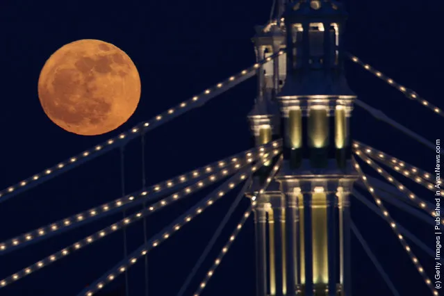 Full Moon Rises Over Albert Bridge In London