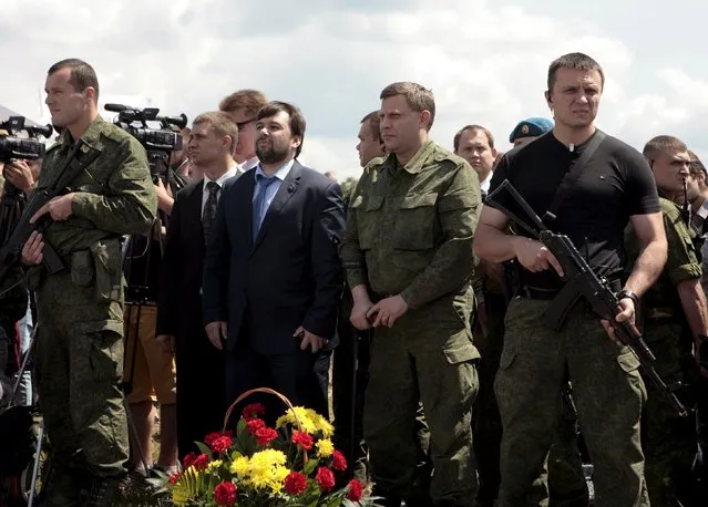 Head of the self-proclaimed Donetsk People's Republic Alexander Zakharchenko (2nd R, front) and senior official Denis Pushilin (3rd R, front) attend a commemoration ceremony at the site of the Malaysia Airlines flight MH17 plane crash near the village of Hrabove in Donetsk region, Ukraine, July 17, 2015. (Photo by Kazbek Basaev/Reuters)