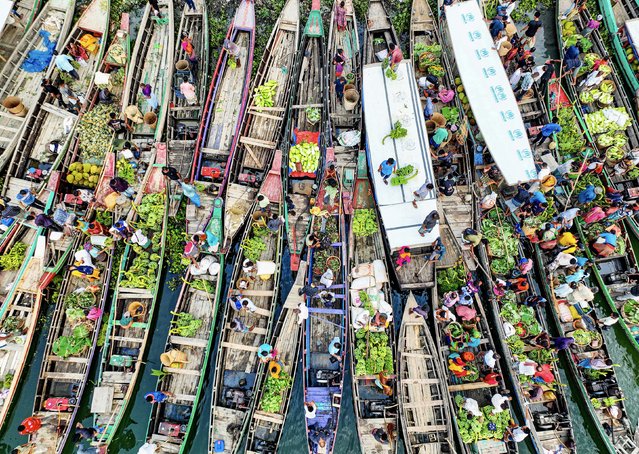 One of the largest floating markets in Bangladesh gathers in Chattogram in the last decade of June 2024, where people from the surrounding areas sell and buy fruit and vegetables on 200 to 300 boats carrying thousands of vendors. (Photo by Mostafijur Rahman Nasim/Solent News)