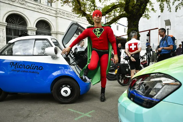 Driver Supercop from team “Maroc” gets out of his Microlino, during the start of the Wave Trophy 2017 tour, on Friday, June 9, 2017, in Zurich, Switzerland. The World Advanced Vehicle Expedition rally, now in its seventh edition, is the brainchild of an environmentally-minded Swiss former teacher who wants to promote plug-in vehicles over carbon-spewing combustion engines. The rally takes the teams over 1,600 kilometers in 8 days. (Photo by Michael Buholzer/Keystone via AP Photo)