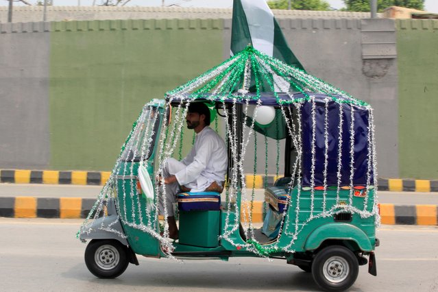 A driver decorates his ricksha with national flag colors to celebrate the country's 78th Independence Day from British rule, in Peshawar, Pakistan, Wednesday, August 14, 2024. (Photo by Muhammad Sajjad/AP Photo)