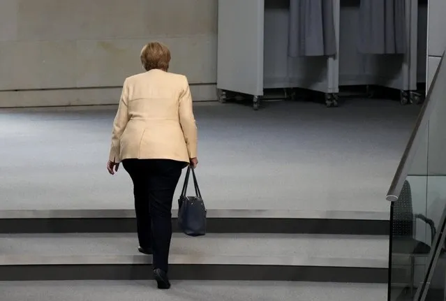 German Chancellor Angela Merkel leaves the plenary hall after a debate about the situation in Germany ahead of the upcoming national election in Berlin, Germany, Tuesday, September 7, 2021. National elections are scheduled in Germany for Sept. 26, 2021. (Photo by Markus Schreiber/AP Photo) 