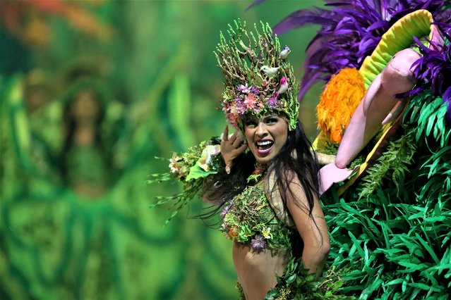 Artists of Boi Caprichoso Association perform during the annual folklore festival known as Boi Bumba at Bumbodromo, in Parintins, an island on the Amazon river about 370km east of Manaus, northern Brazil, on July 3, 2023. Boi Bumba is considered the biggest outdoor opera, which is performed by two competing sides, the Garantido (in Red) and Caprichoso (in Blue), for three nights on the last weekend of June. The themes, costumes, and songs are based on the native cultures along the Amazon River. The float can be over 30 meters high. (Photo by Michael Dantas/AFP Photo)