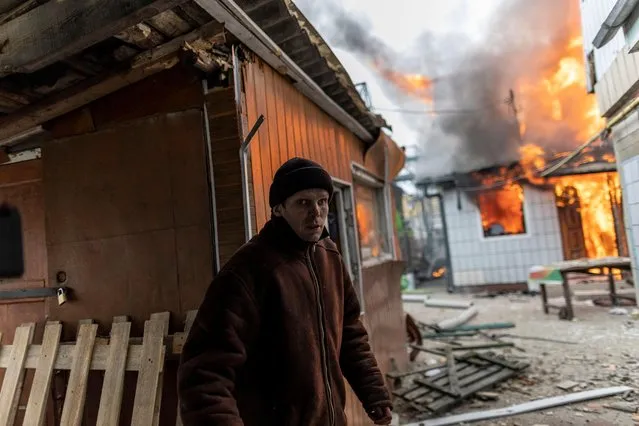 A local resident reacts as a house is on fire after heavy shelling on the only escape route used by locals to leave the town of Irpin, while Russian troops advance towards the capital, 24km from Kyiv, Ukraine on March 6, 2022. (Photo by Carlos Barria/Reuters)