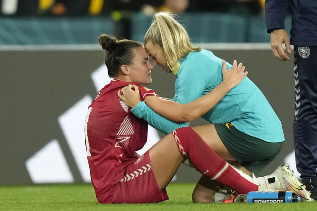 Denmark's Katrine Veje, left, is comforted by Australia's Charlotte Grant, right, after the Women's World Cup round of 16 soccer match between Australia and Denmark at Stadium Australia in Sydney, Australia, Monday, August 7, 2023. (Photo by Rick Rycroft/AP Photo)