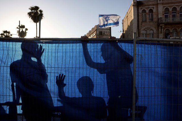 Young Israelis are silhouetted as people participate in the annual Jerusalem Day march, near Damascus Gate in Jerusalem, on June 5, 2024. As in years past, some marchers scuffled with Palestinians in Jerusalem's walled Old City, flashpoint site of shrines to the three major faiths. Police said 18 people, among them teenagers, were arrested, including for assaulting a journalist. (Photo by Ronen Zvulun/Reuters)